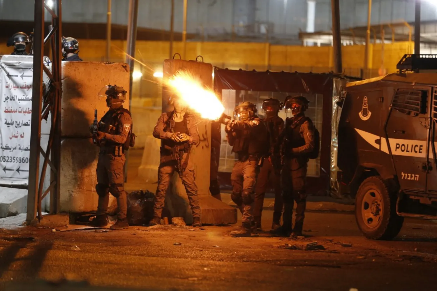 Israeli soldiers fire tear gas at Palestinian demonstrators in Jerusalem, at the Qalandiya checkpoint between Ramallah and Jerusalem, in the occupied West Bank, on May 11, 2021. (AFP)