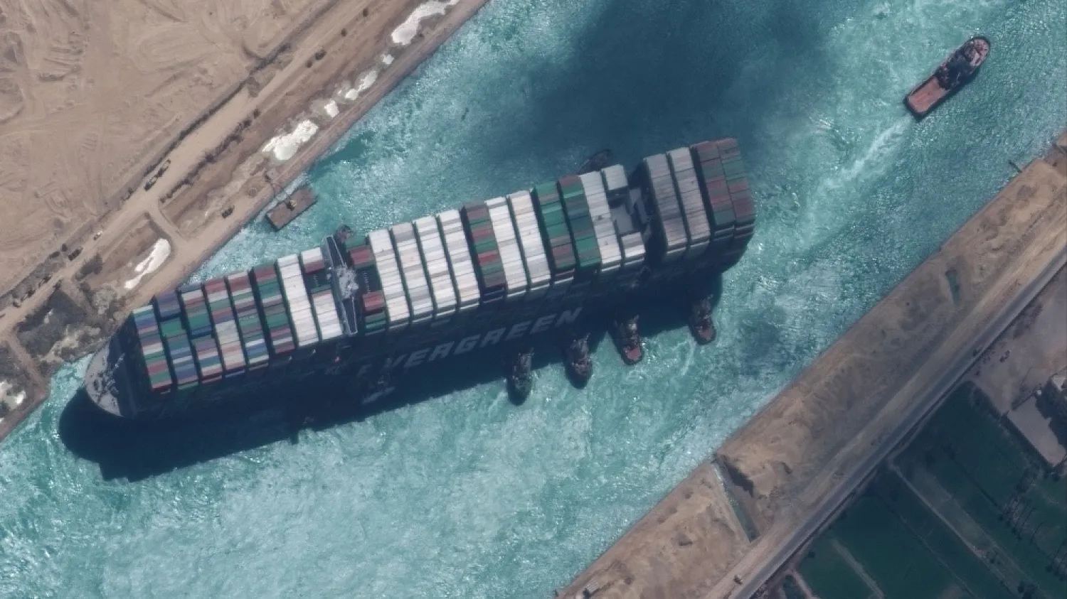 Tugboats try to reposition the Ever Given container ship in the Suez Canal, Egypt, March 29, 2021. (MAXAR Technologies via EPA)