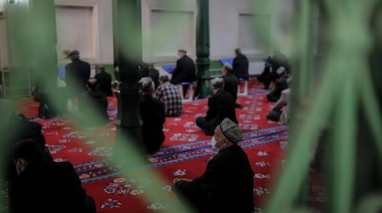 A group of Uyghurs pray at a mosque in Xinjiang. (EPA)