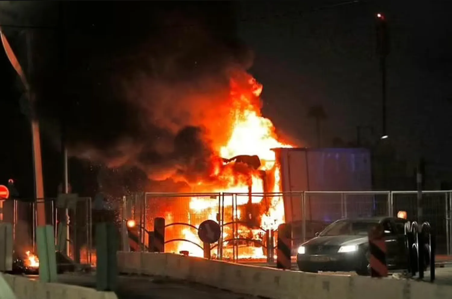 A truck burns at the entrance to the mixed Jewish-Arab city of Lod in central Israel - AFP