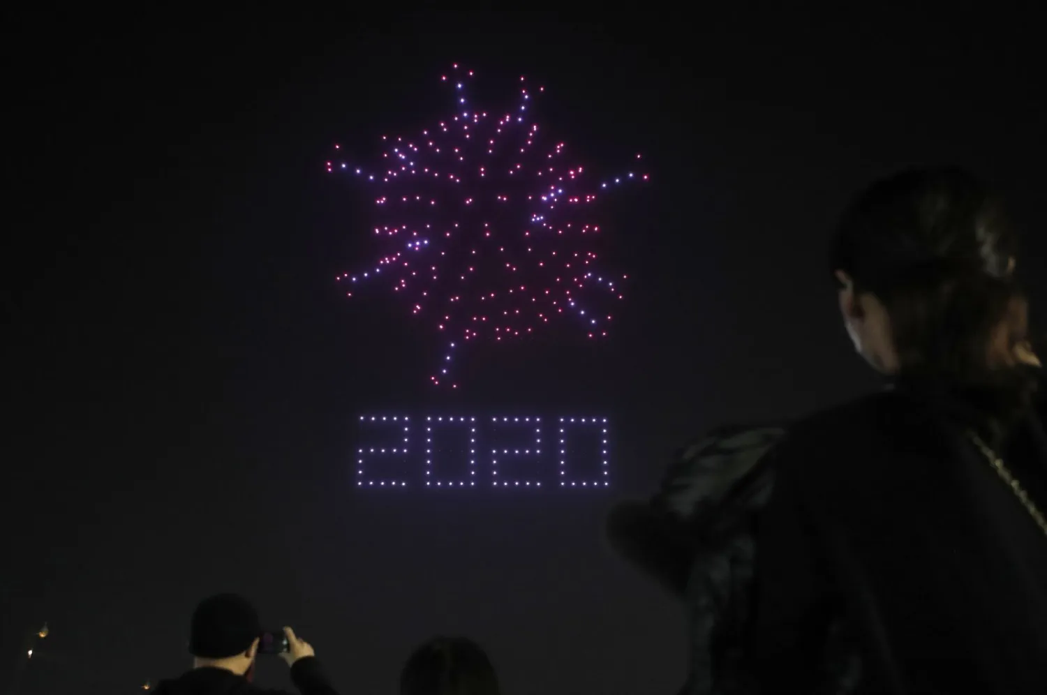 Over 300 drones fly over the Olympic Park, creating the shape of the coronavirus along with messages of encouragement, amid the coronavirus battle in Seoul, South Korea, Nov. 13, 2020. (AP Photo)