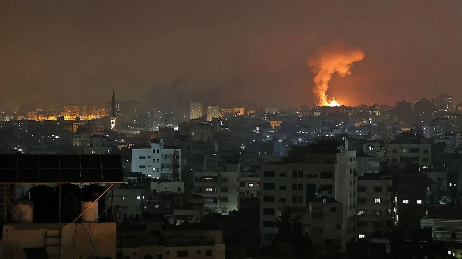 An explosion lights the sky following an Israeli airstrike on Beit Lahia in the northern Gaza Strip, May 14, 2021. (AFP)