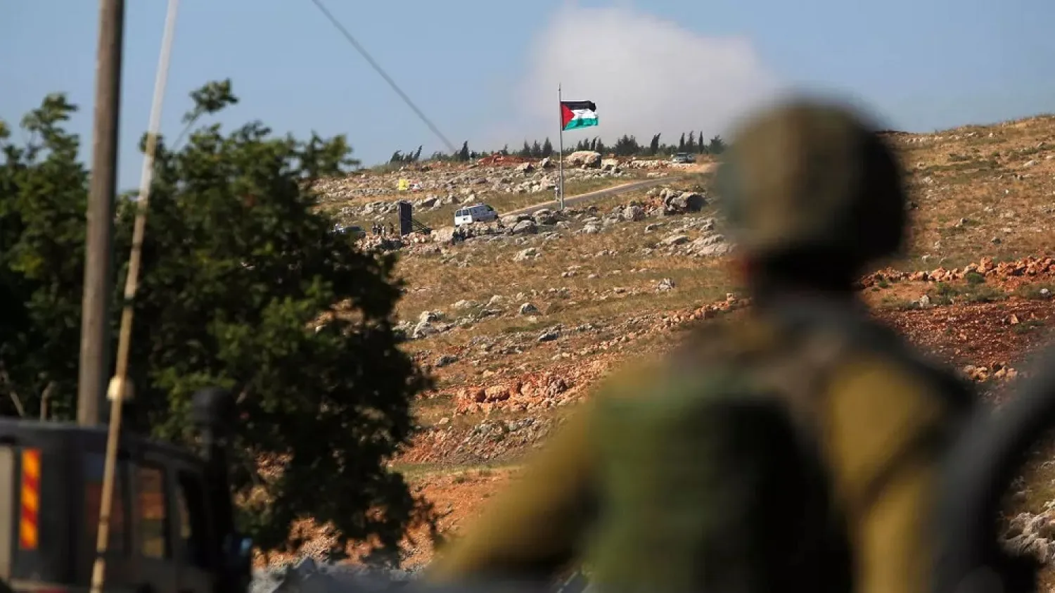 An Israeli soldier deployed in the northern town of Metulla looks across the border strip with Lebanon. (AFP)