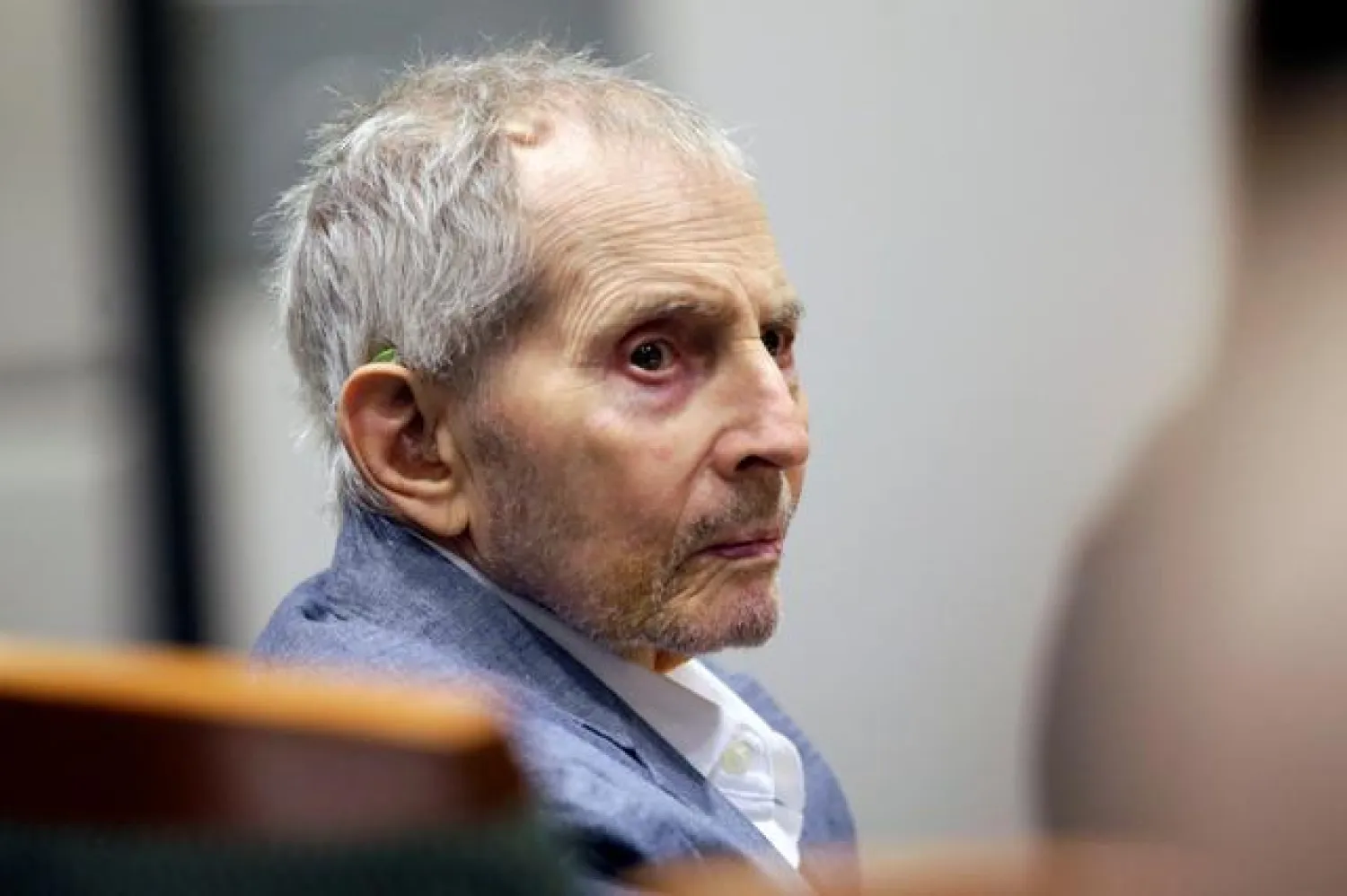 FILE PHOTO: Real estate heir Robert Durst looks over during his murder trial in Los Angeles, California, U.S., March 10, 2020. Alex Gallardo/Pool via Reuters/File Photo