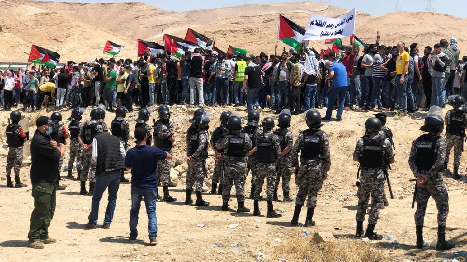 Demonstrators hold Palestinian flags during a protest to express solidarity with the Palestinian people, in Karameh, Jordan valley, Jordan May 14, 2021. (Reuters)
