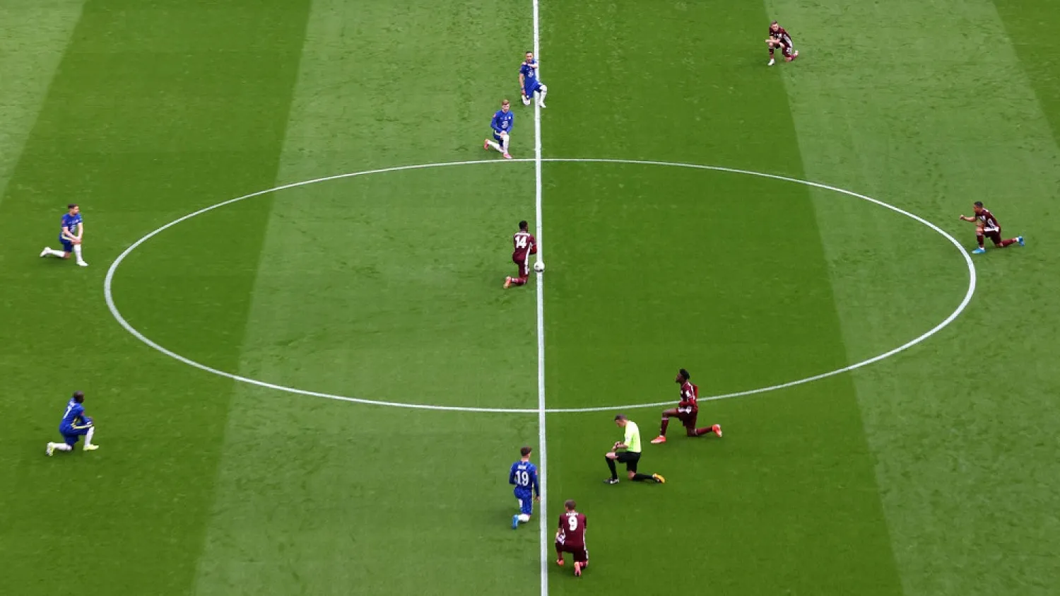 Chelsea and Leicester players take a knee before the match. (Getty Images)