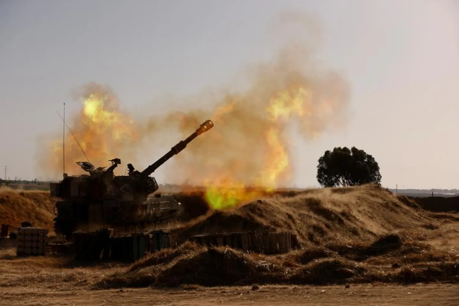 An Israeli mobile artillery unit fires near the border between Israel and the Gaza Strip, May 12, 2021. REUTERS/Amir Cohen

