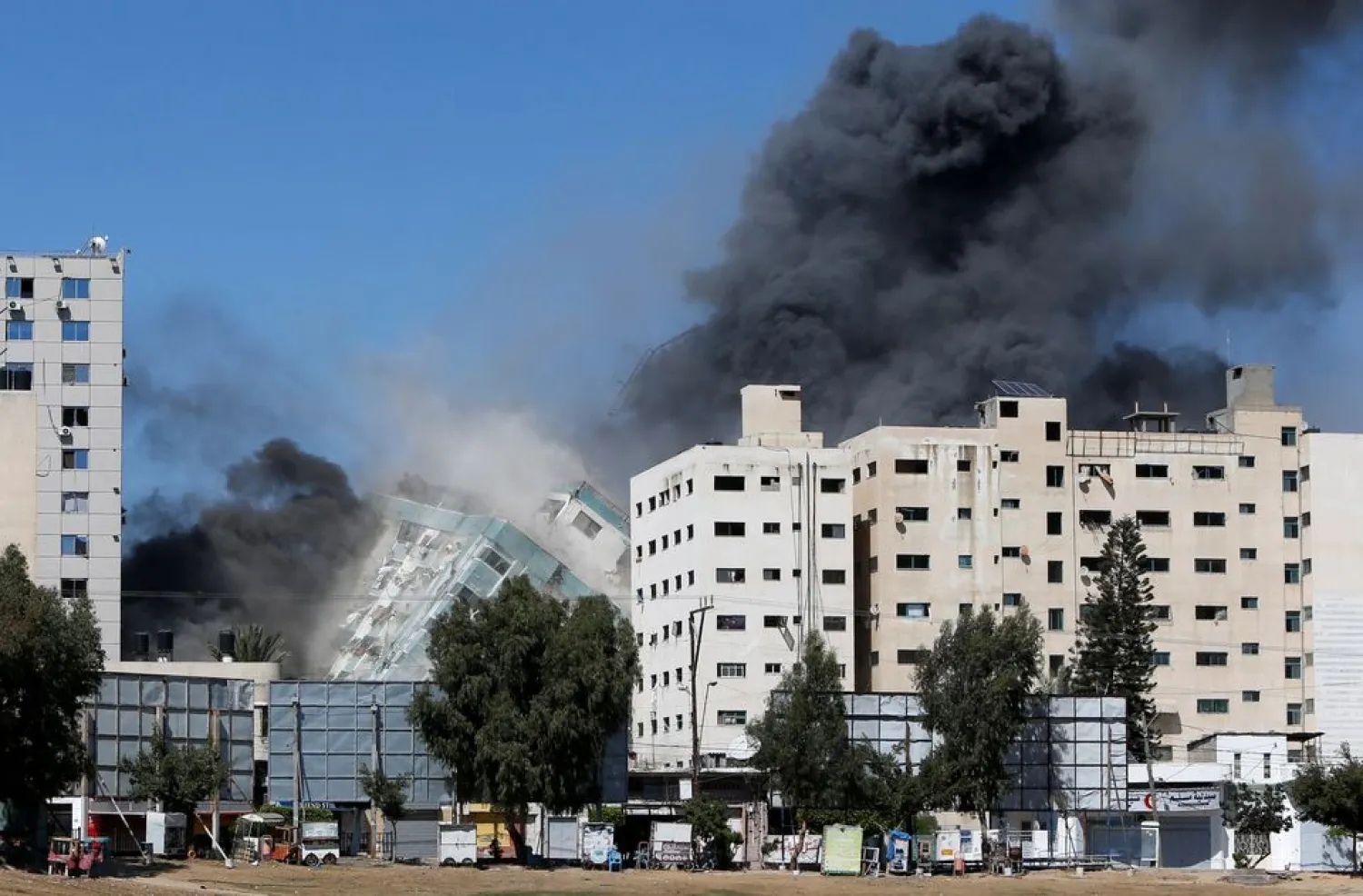 Gaza tower housing AP, Al Jazeera collapses after missile strike in Gaza city, May 15, 2021. (Reuters)