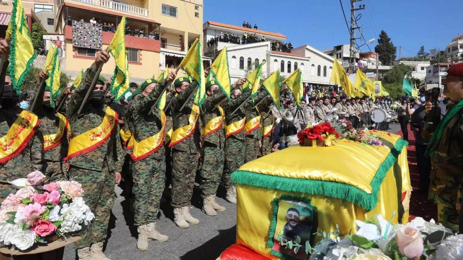 Members of his family gathered around the coffin of Mohamed Tahan in his home town of Adloun, in southern Lebanon, to bid farewell. (AFP)