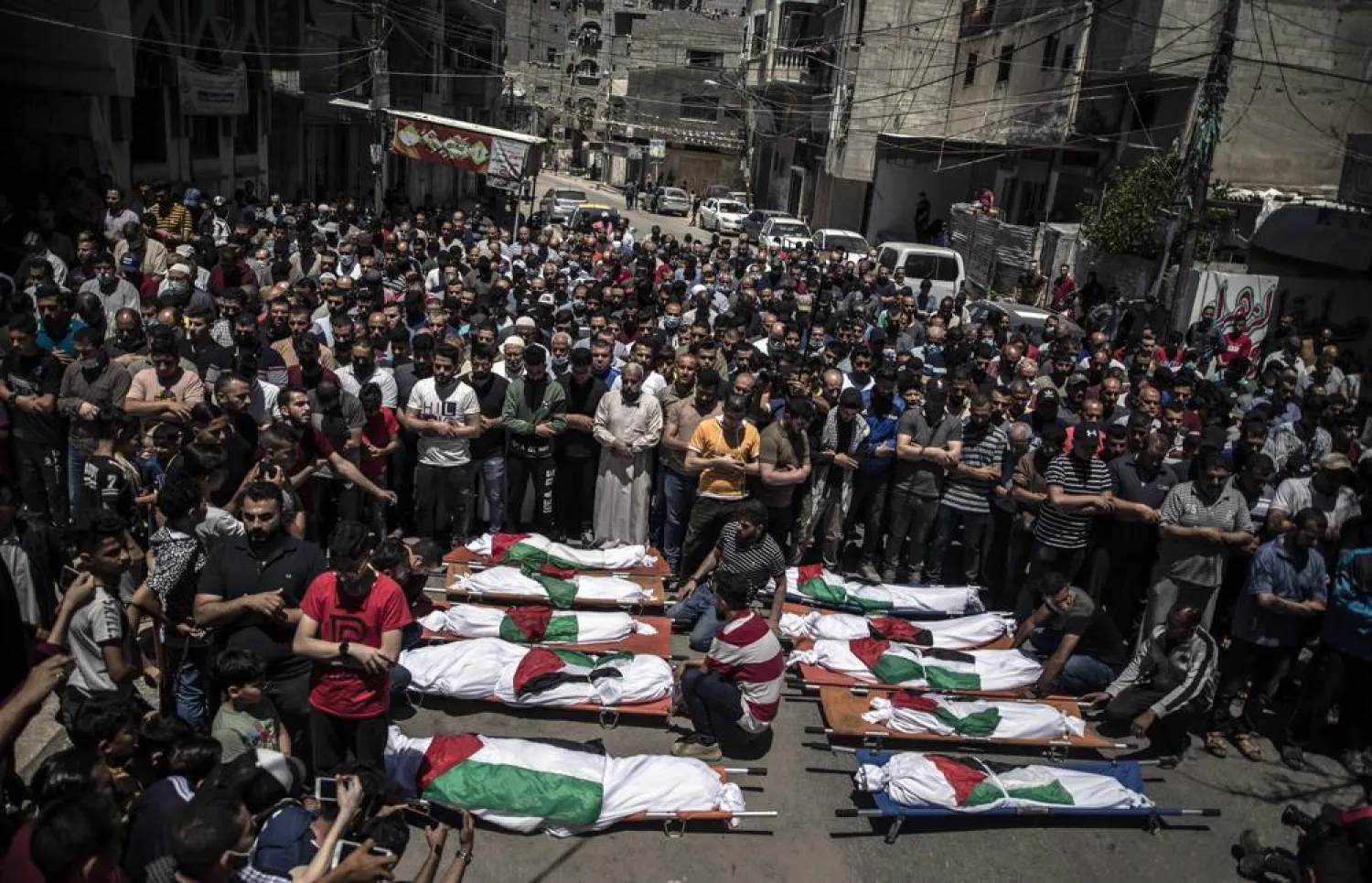 Palestinians attend the funeral of two women and eight children of the Abu Hatab family in Gaza City, who were killed after an Israeli air strike, Saturday, May 15, 2021. (AP Photo/Khalil Hamra)

