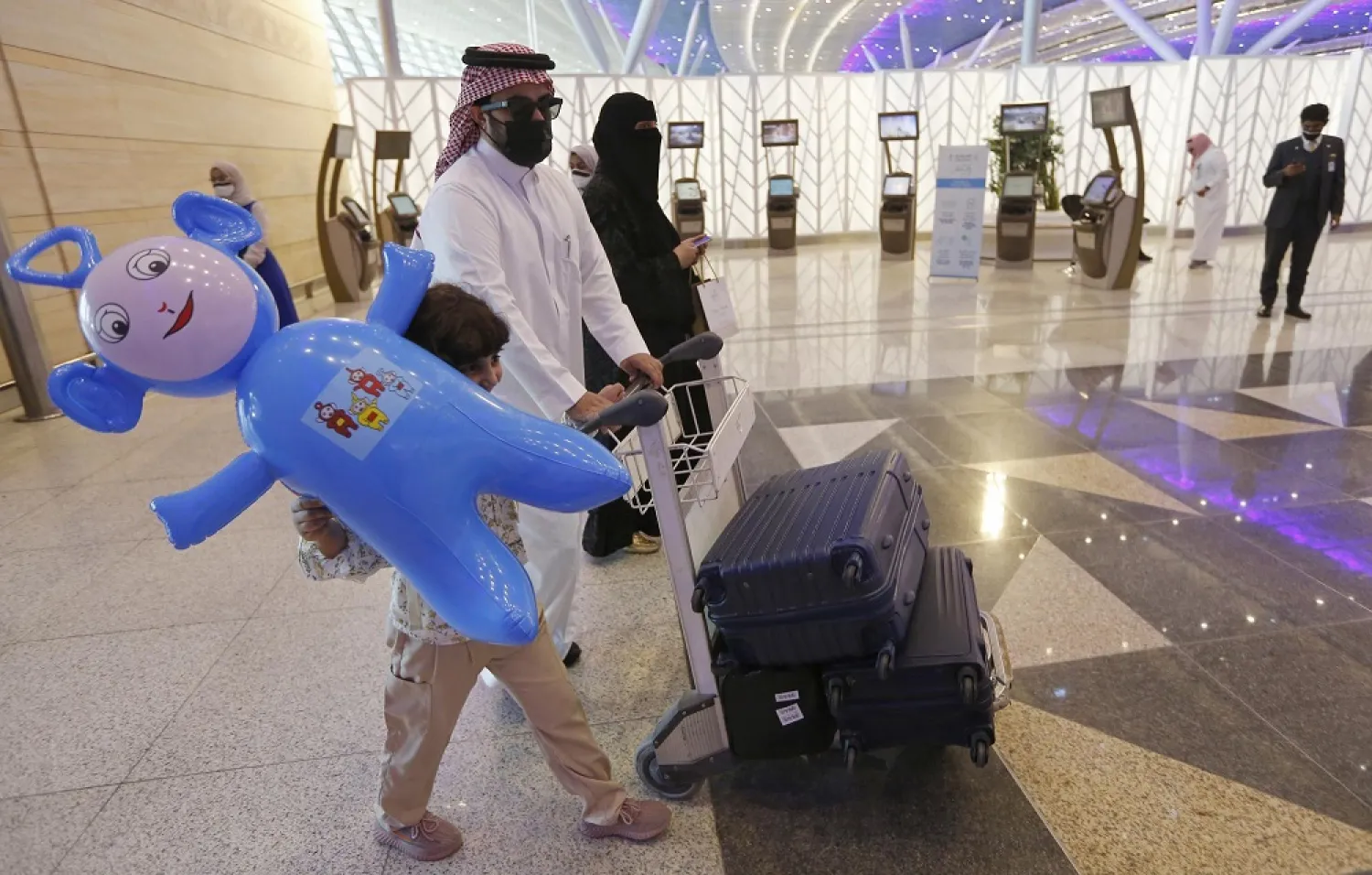 Saudi flock to airports for foreign travel after curbs are eased. (AP)