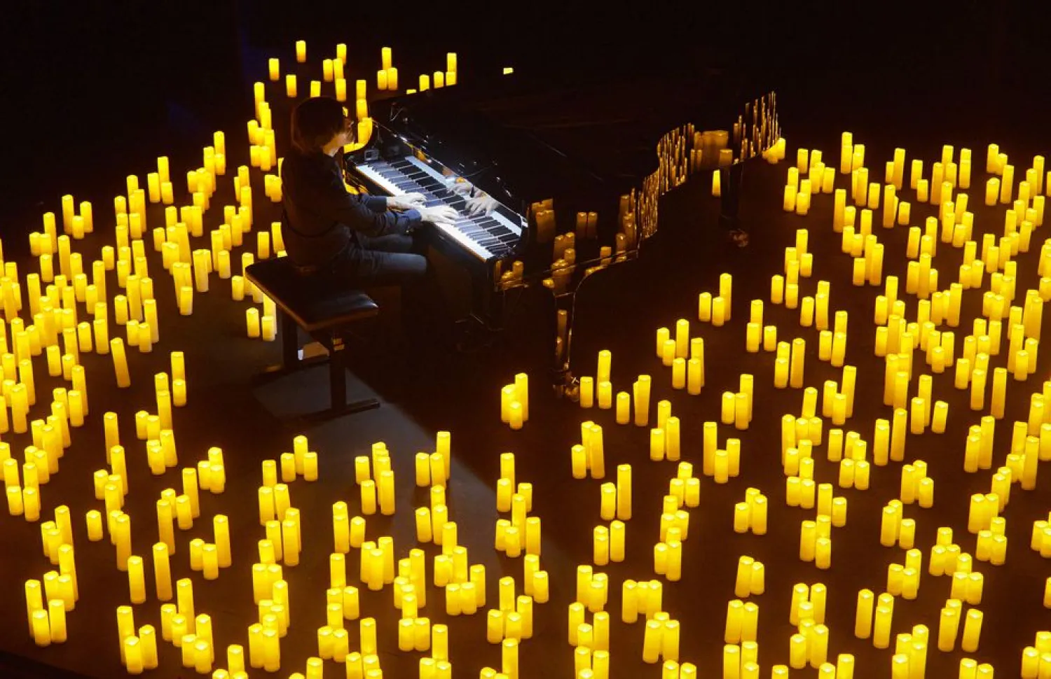 French pianist Eric Artz performs Japanese animated theme songs illuminated with hundreds of candles as during easing of lockdown measures against the coronavirus disease (COVID-19) outbreak during the Candlelight series in Les Salons in Geneva, Switzerland, May 19 , 2021. Reuters