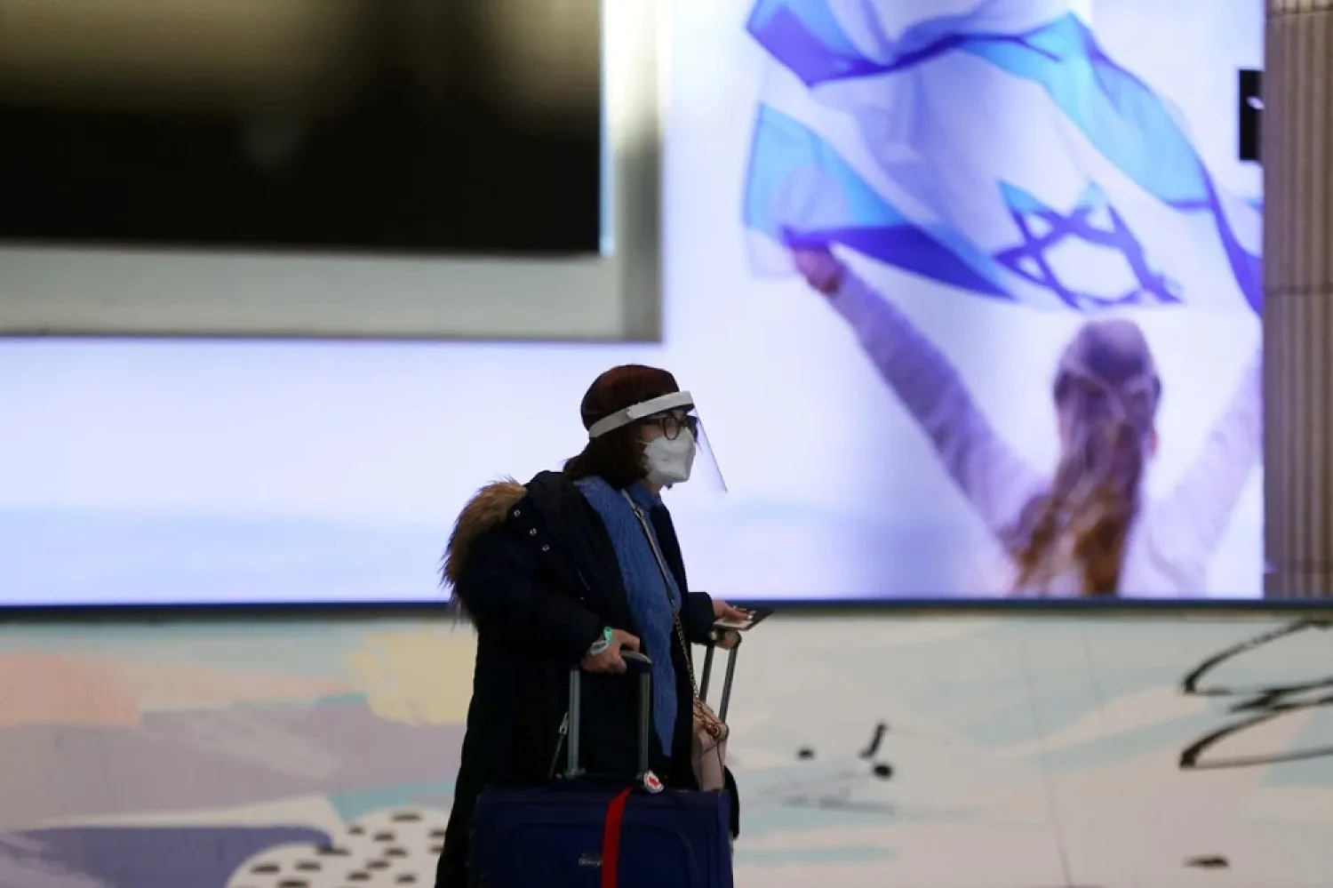 A passenger walks inside a terminal at Ben Gurion international airport before Israel bans international flights, in order to stop the spread of the coronavirus and new coronavirus strains, in Lod, Israel, January 25, 2021. (Reuters)