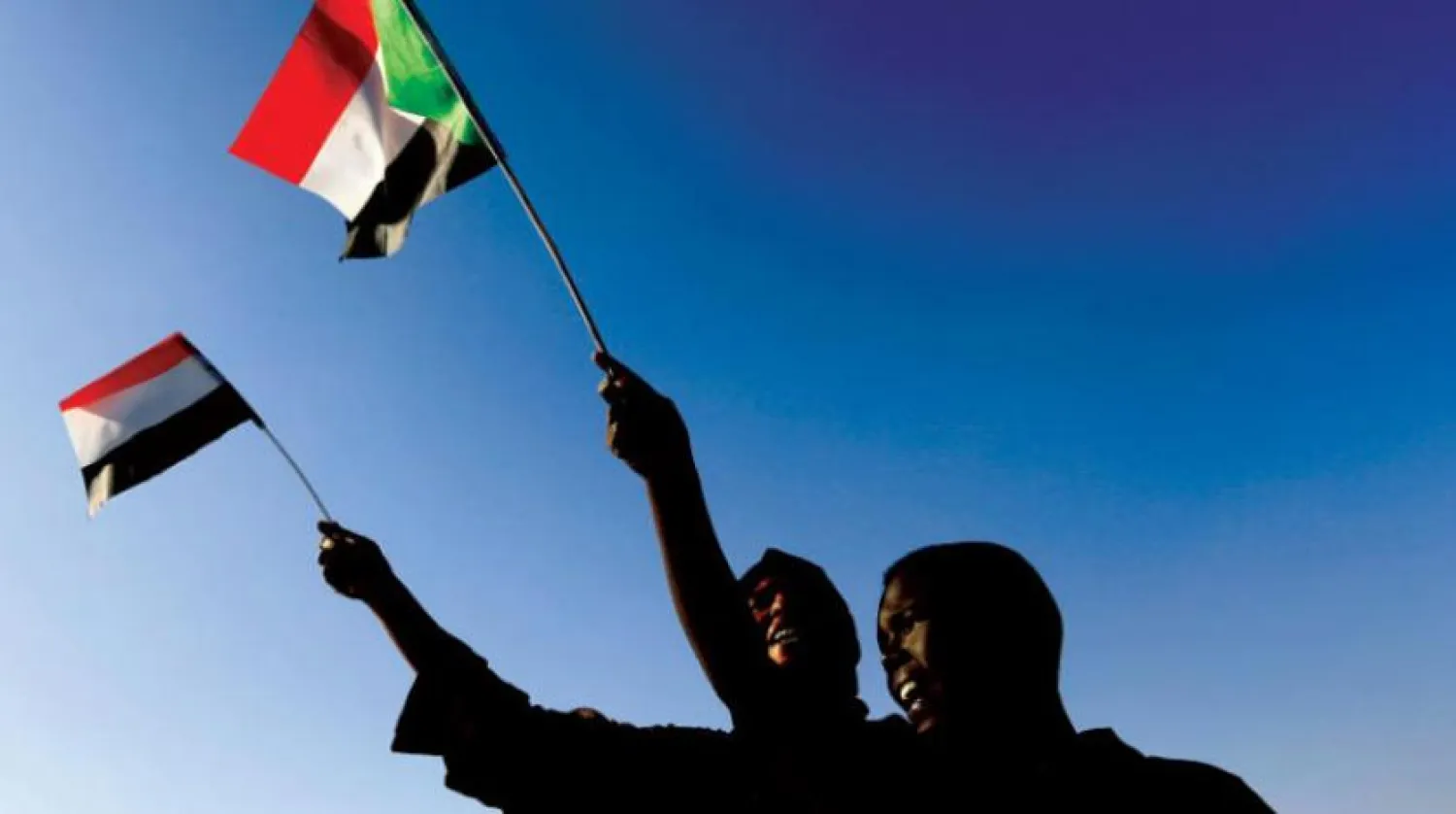 İki Sudanlı geçtiğimiz Aralık ayında Hartum’da devrimin yıl dönümünü kutluyor. (Reuters)