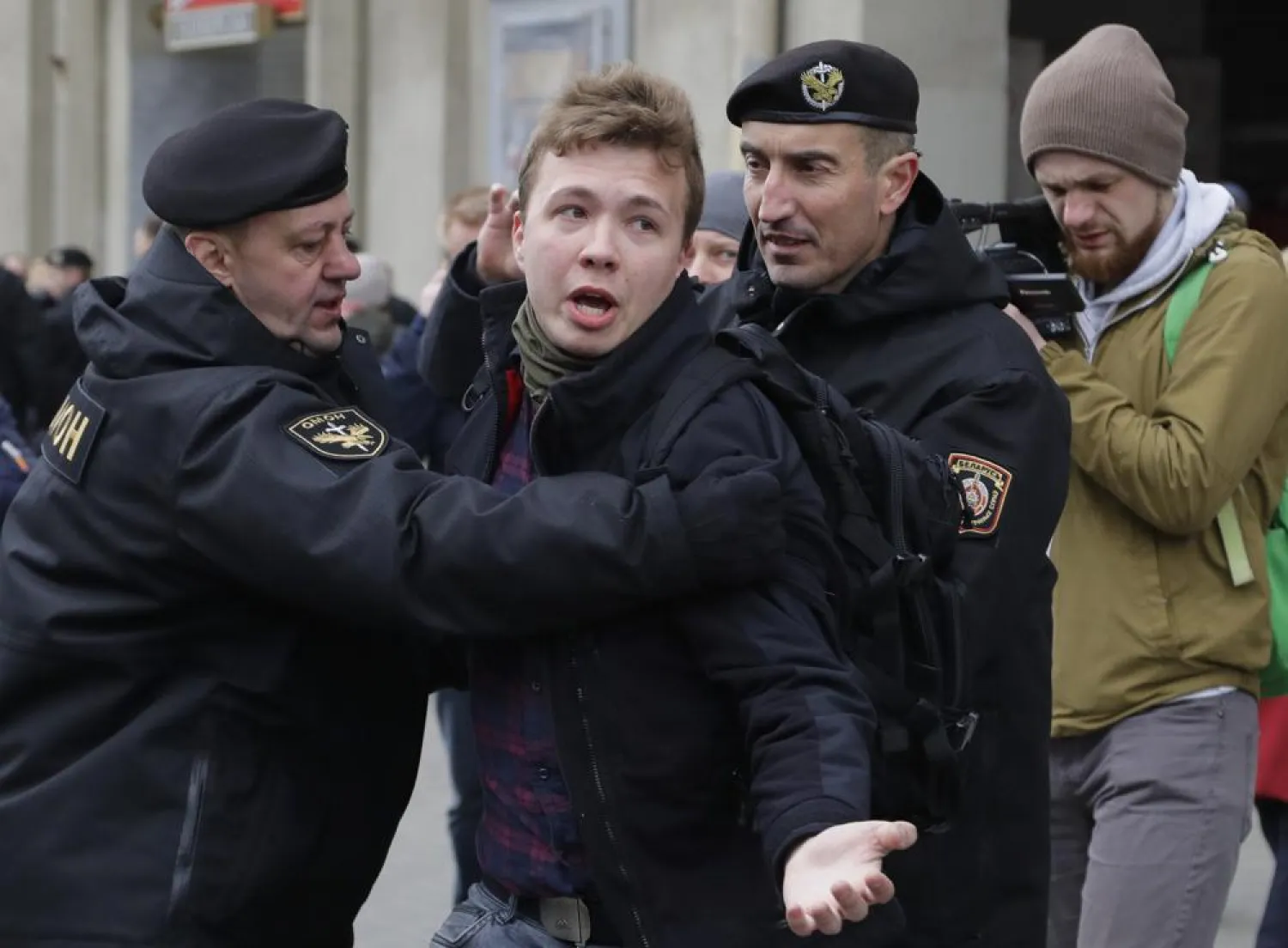 In this Sunday, March 26, 2017 file photo, Belarus police detain journalist Raman Pratasevich, center, in Minsk, Belarus. (AP)