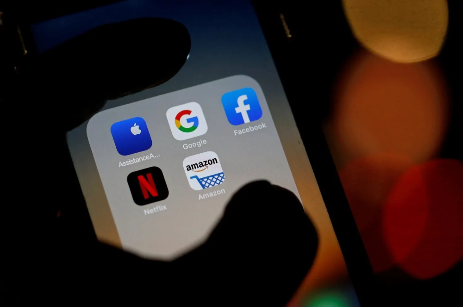 The logos of mobile apps, Google, Amazon, Facebook, Apple and Netflix, are displayed on a screen, Dec. 3, 2019. (Reuters)