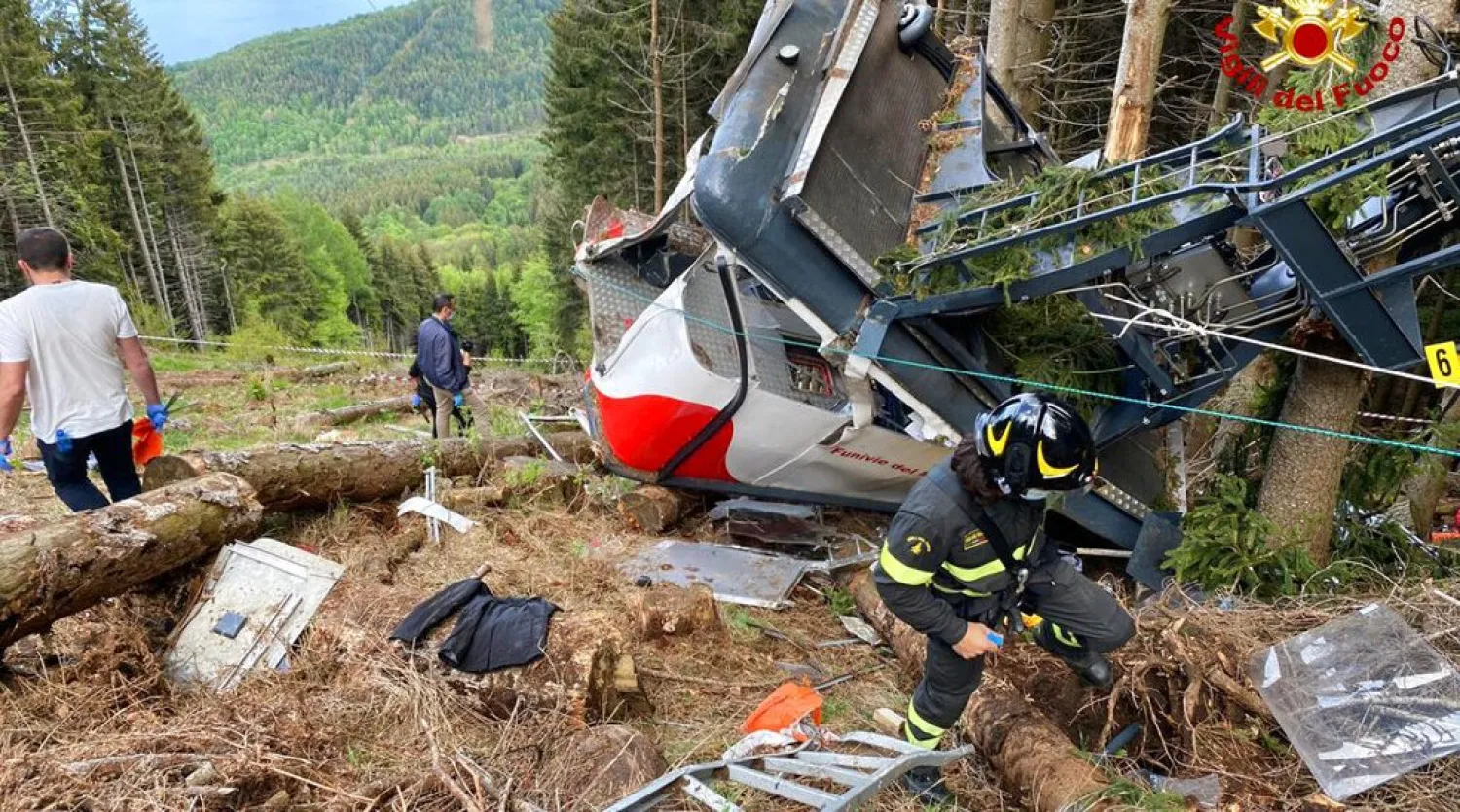 Rescuers work by the wreckage of a cable car after it collapsed near the summit of the Stresa-Mottarone line in the Piedmont region, northern Italy, May 23, 2021. Italian Vigili del Fuoco Firefighters via AP