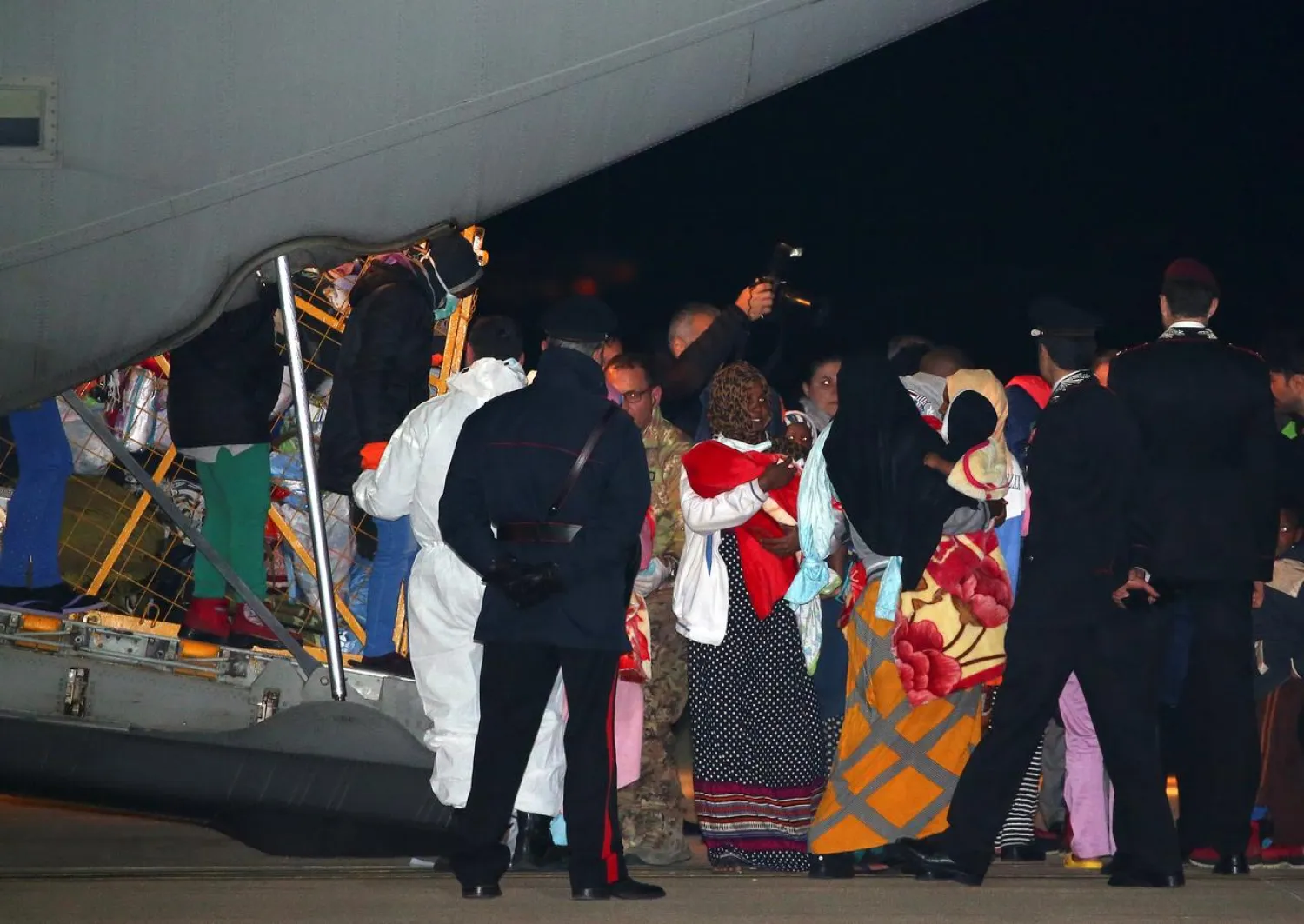 Evacuated migrants from Tripoli in Libya arrive at the military airport Pratica di Mare in Rome, Italy, December 22, 2017. REUTERS/Alessandro Bianchi