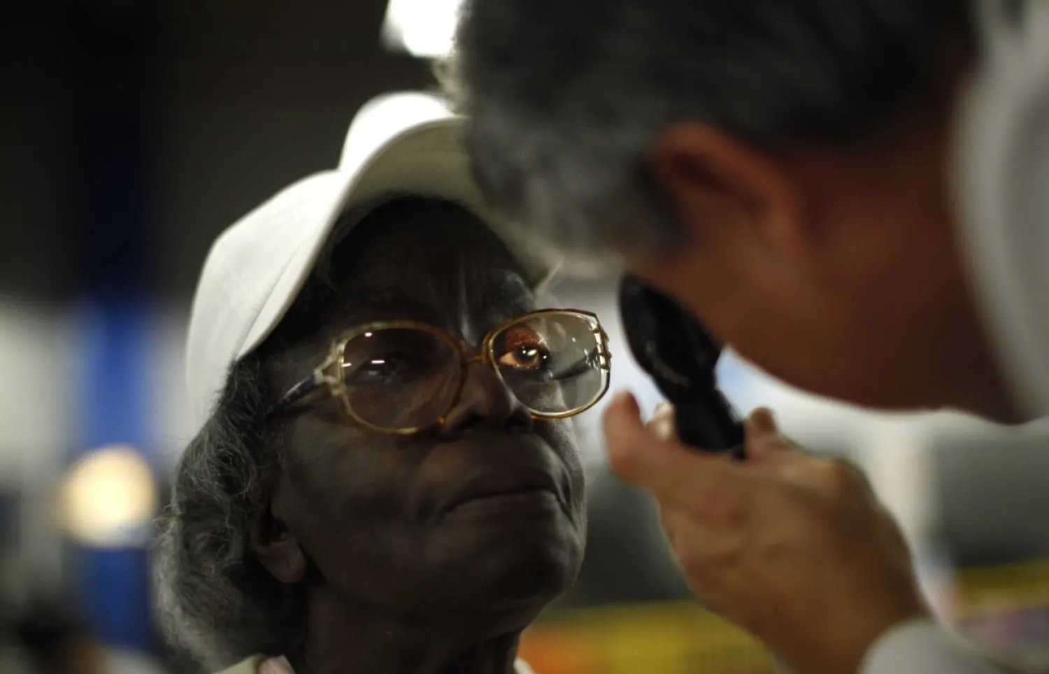 FILE - A woman receives an eye exam at the Care Harbor/LA free clinic in Los Angeles, September 27, 2012. Reuters