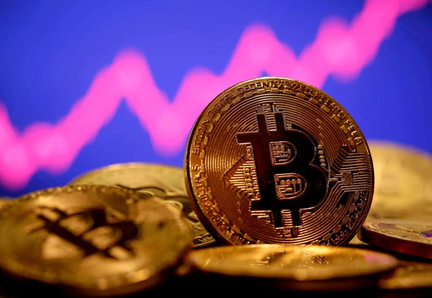 A representation of virtual currency Bitcoin is seen in front of a stock graph in this illustration taken January 8, 2021. REUTERS/Dado Ruvic/File Photo/File Photo

