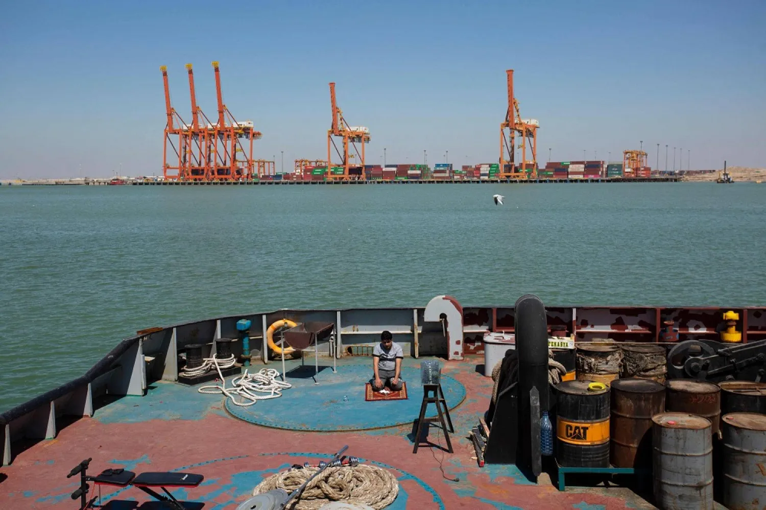 A man prays aboard a maintenance vessel at the port of Umm Qasr, south of Iraq's southern city of Basra. (AFP)