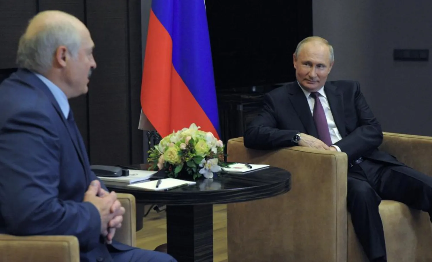 Russian President Vladimir Putin, right, smiles as he listens to Belarusian President Alexander Lukashenko during their meeting in the Black Sea resort of Sochi, Russia, Friday, May 28, 2021. (AP)