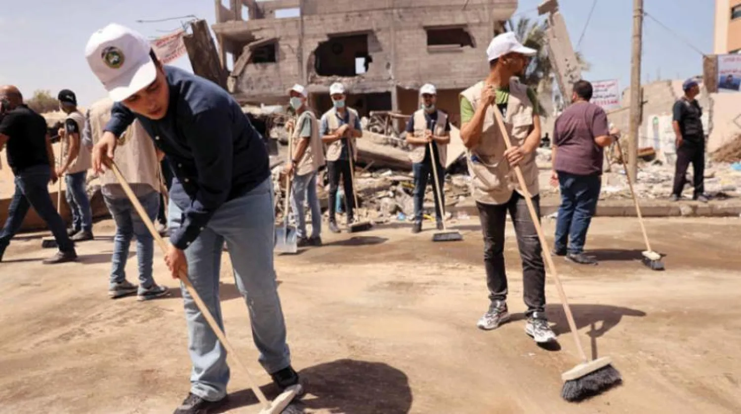 Volunteers take part in cleaning the streets of Gaza City on Saturday, May 29, 2021. (AFP) 