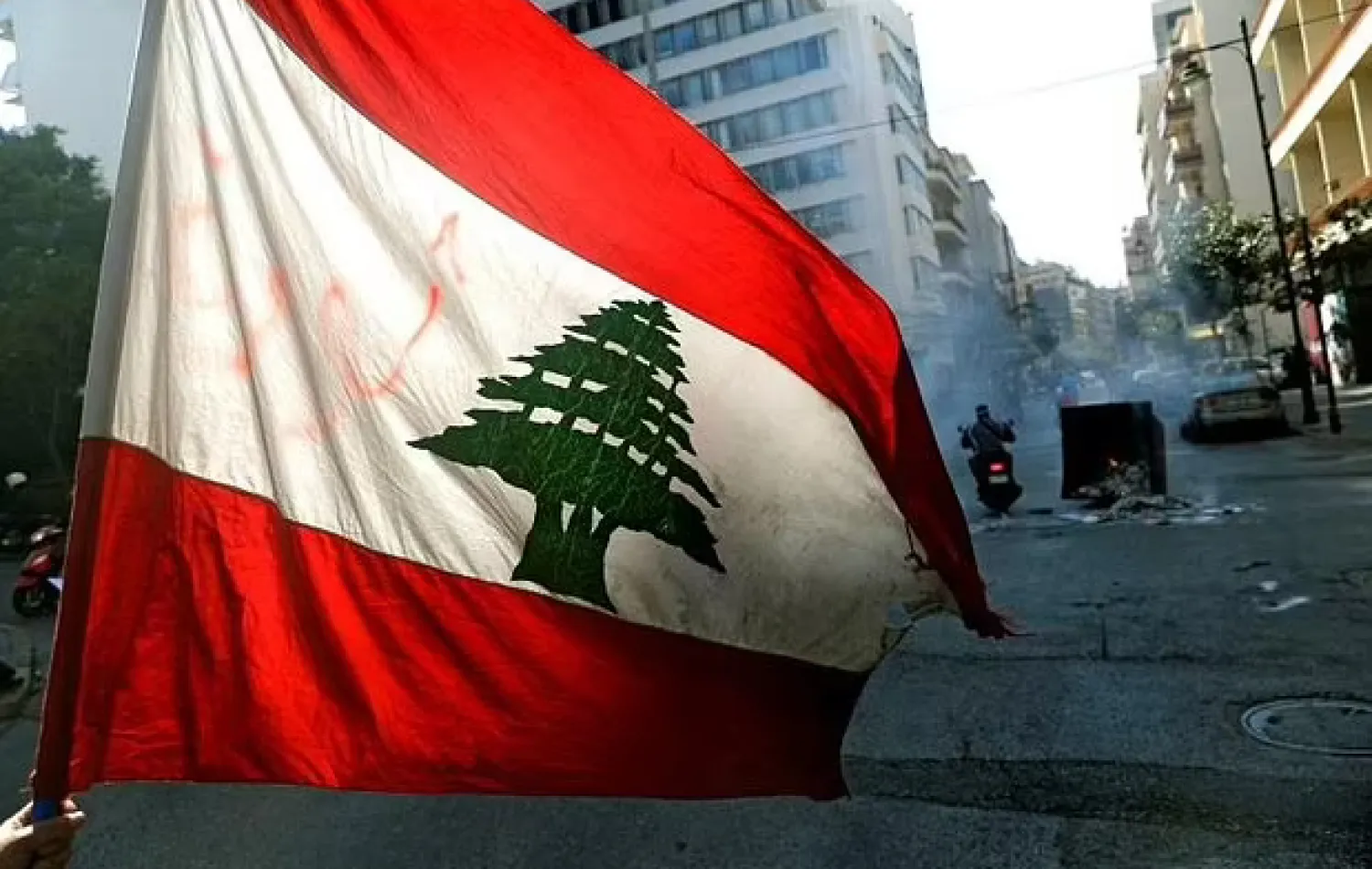 Anti-government demonstrators block the street with burning garbage dumpsters in front of Lebanon's central bank in this file picture taken on March 16, 2021 - AFP