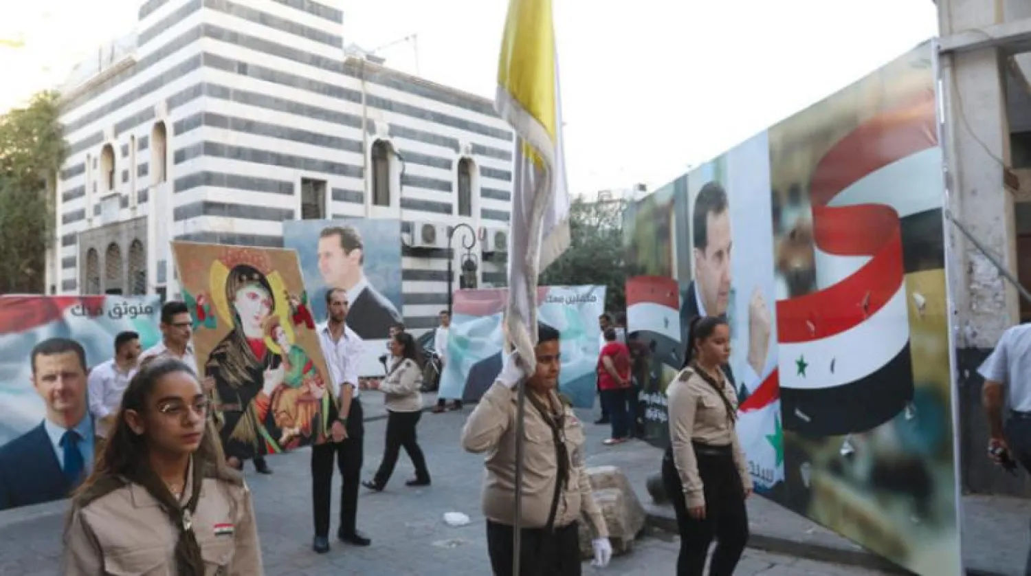People celebrate Assad's victory in Damascus. (EPA)
