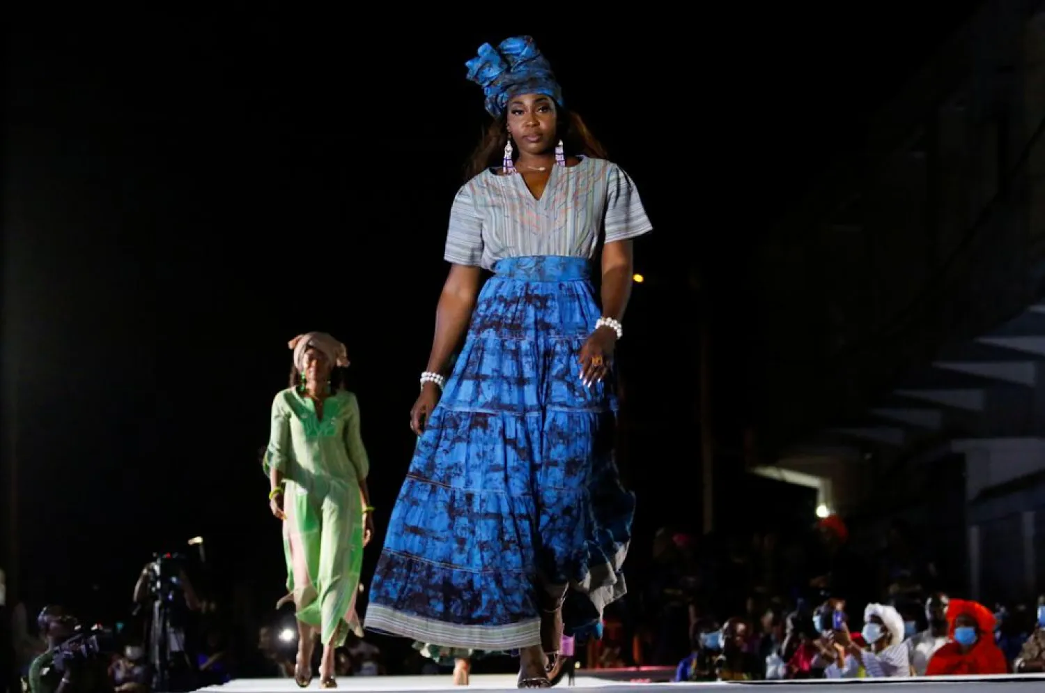 Models present outfits created by Pathe'O, during a fashion show marking the 50 years of his career and the inauguration of Maison Pathe'O fashion house in Abidjan, Ivory Coast May 29, 2021. (Reuters)