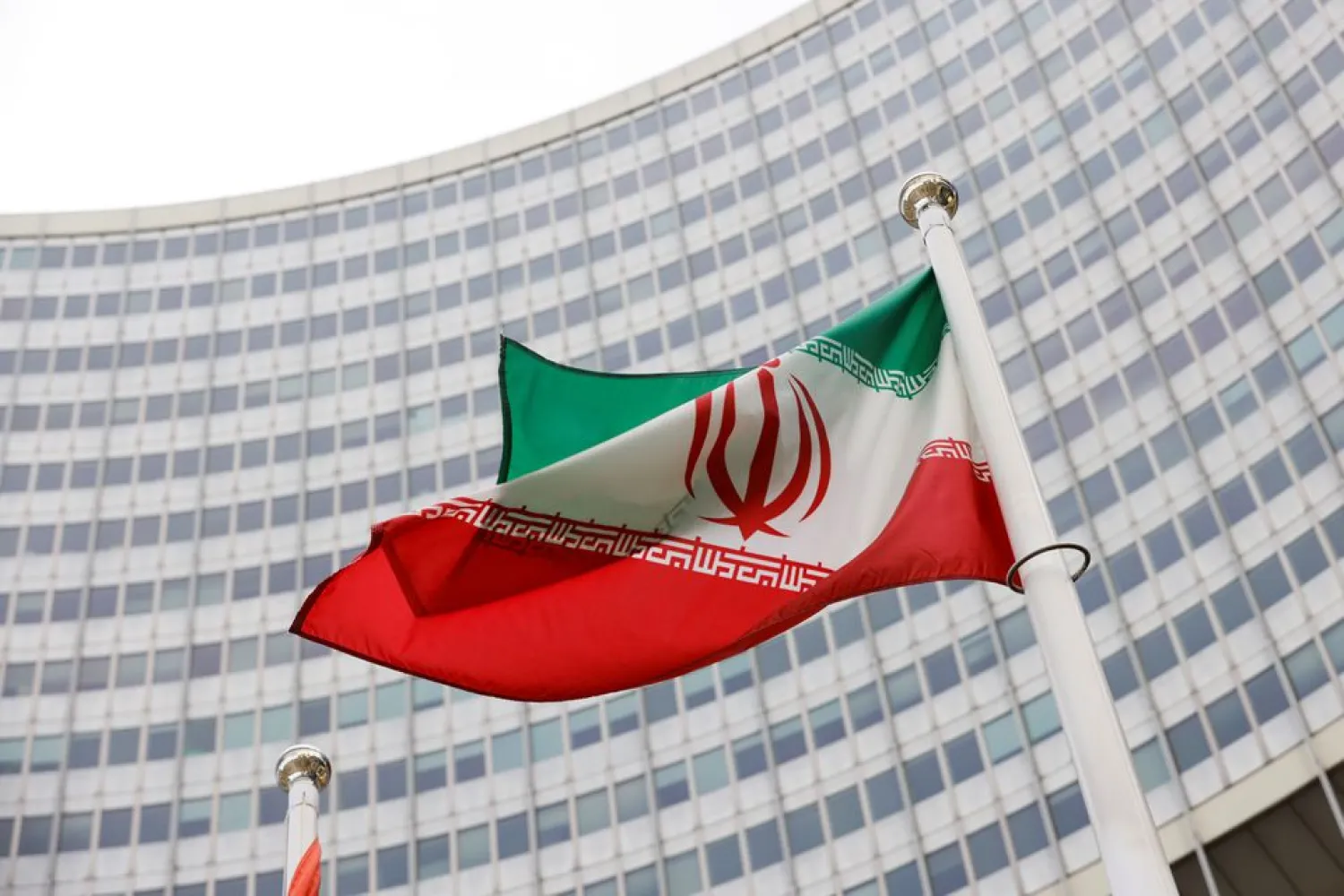 The Iranian flag waves in front of the International Atomic Energy Agency (IAEA) headquarters, amid the coronavirus disease (COVID-19) pandemic, in Vienna, Austria May 23, 2021. (Reuters)