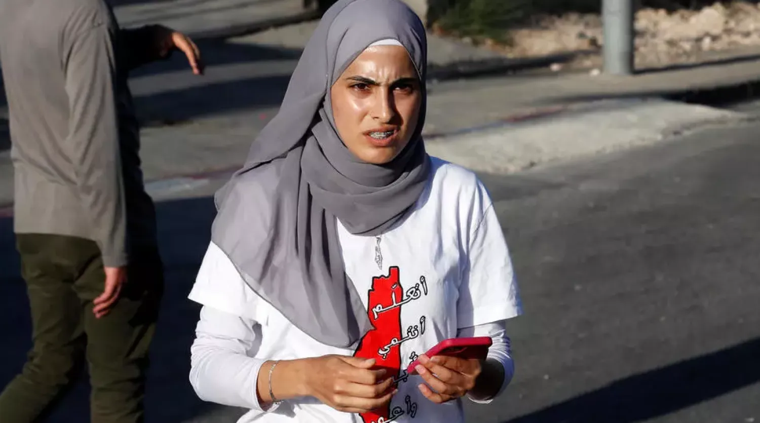 Palestinian activist Mona el-Kurd takes part in a rally to demand the reopening of the Israeli police checkpoint at the entrance of the Sheikh Jarrah neighborhood on May 29; her father said she was arrested on June 6 - AFP

