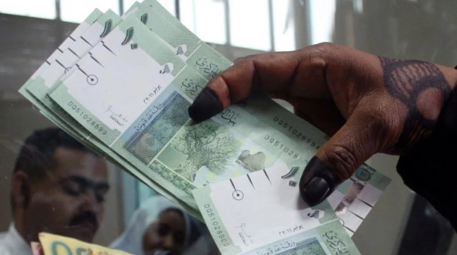  A woman displays Sudan's currency at the central bank in Khartoum, Sudan. (AP) 
