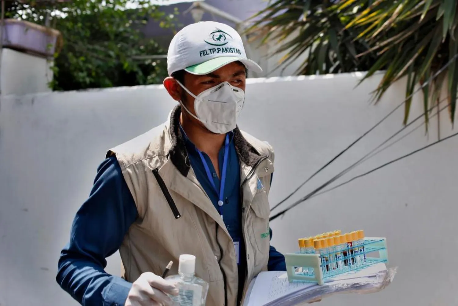 A health worker leaves after collecting samples from a family for coronavirus testing at a neighborhood in Islamabad, Pakistan, Monday, June 8, 2020.  (AP Photo/Anjum Naveed) 

