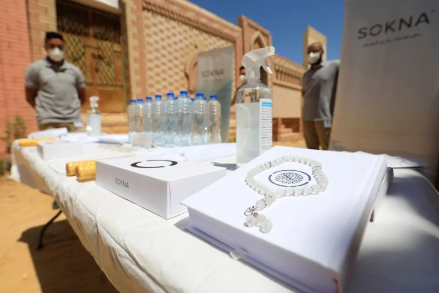 Employees of Sokna funeral service company stand near service desk of Quran and prayer beads during training amid the coronavirus pandemic on the outskirts of Cairo, Egypt May 19, 2021. (Reuters)
