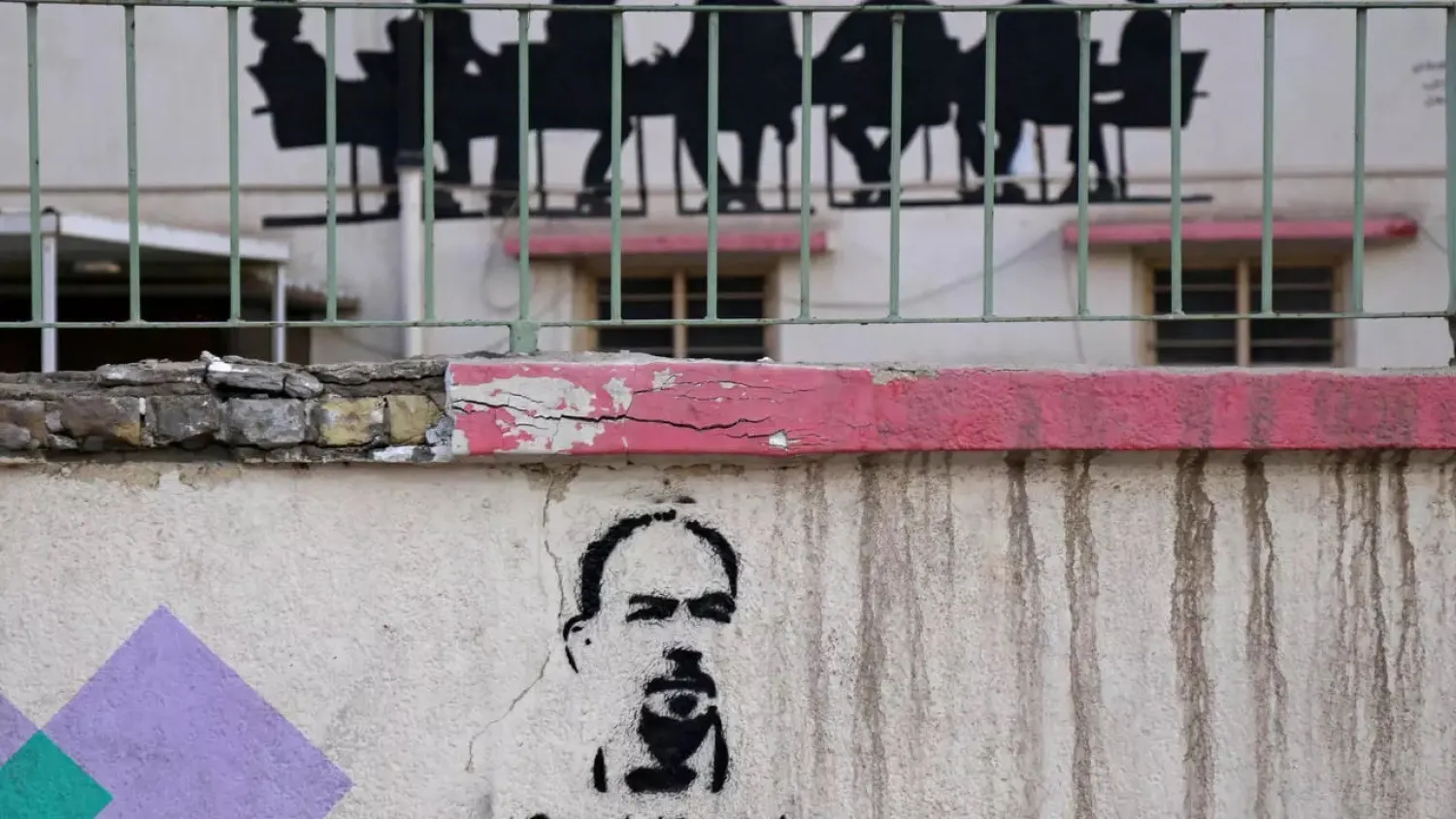 Graffiti reads in Arabic “Where's my killer” and shows prominent Iraqi anti-government activist Ihab al-Wazni, who was shot dead on May 9 in the city of Karbala. (AFP)