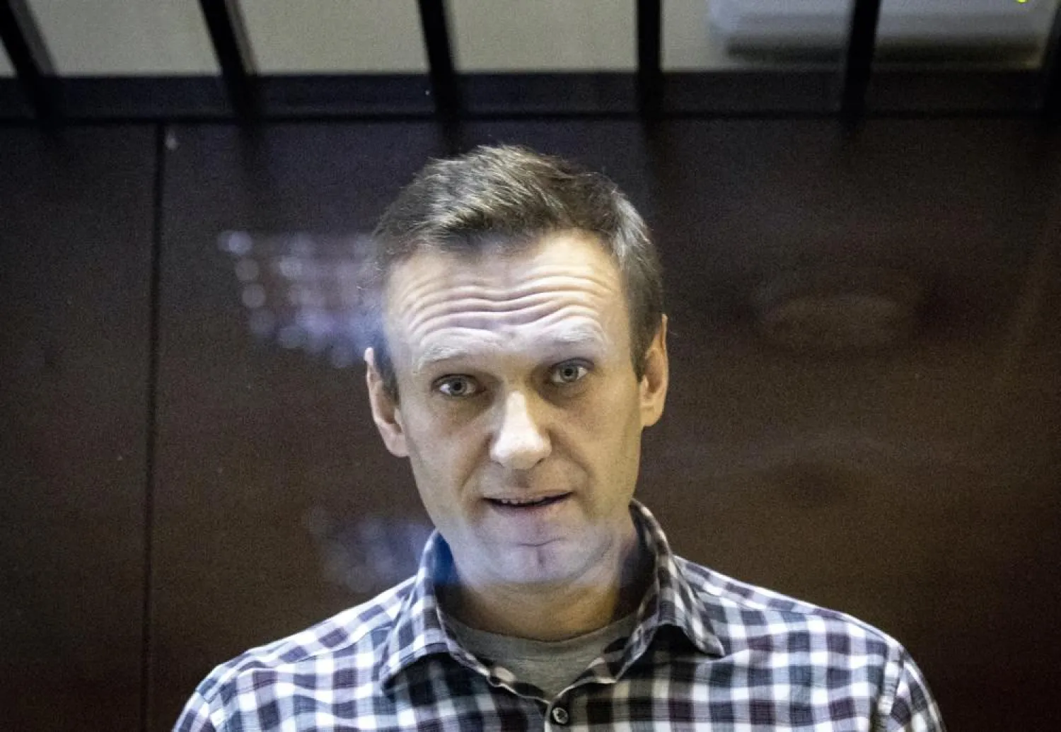 In this Saturday, Feb. 20, 2021, file photo, Russian opposition leader Alexei Navalny looks at photographers standing in the Babuskinsky District Court in Moscow, Russia. (AP)