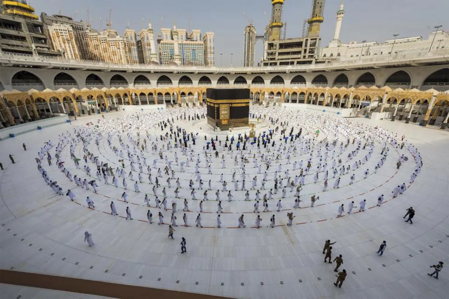 FILE - In this July 31, 2020, file photo, pilgrims walk around the Kaabah at the Grand Mosque in the Muslim holy city of Makkah, Saudi Arabia.  (Saudi Ministry of Media via AP, File)
