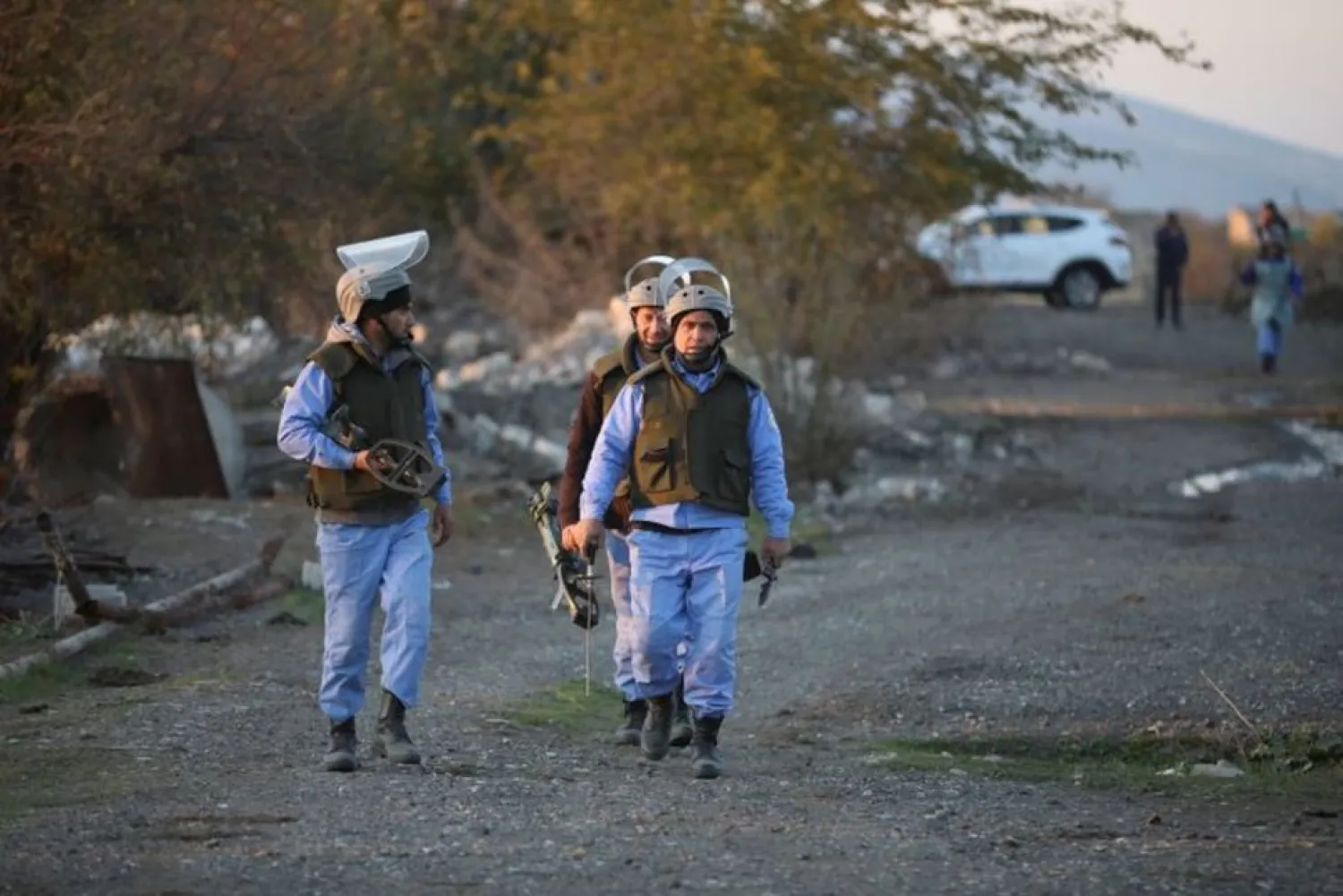 Azerbaijani service members walk during mine lifting in Agdam town in the region of Nagorno-Karabakh, November 24, 2020. Picture taken November 24, 2020. (Reuters)