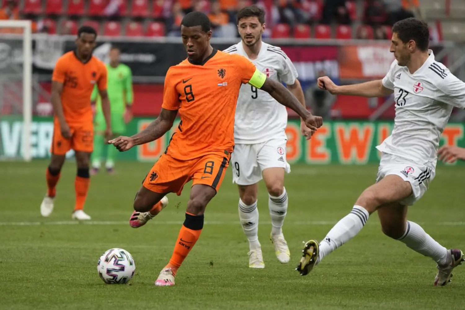 Netherlands' Georginio Wijnaldum, center, and Georgia's Lasha Dvali, right, vie for the ball during a friendly match in the run-up to the Euro 2020 tournament, in Enschede, June 6, 2021. (AP)