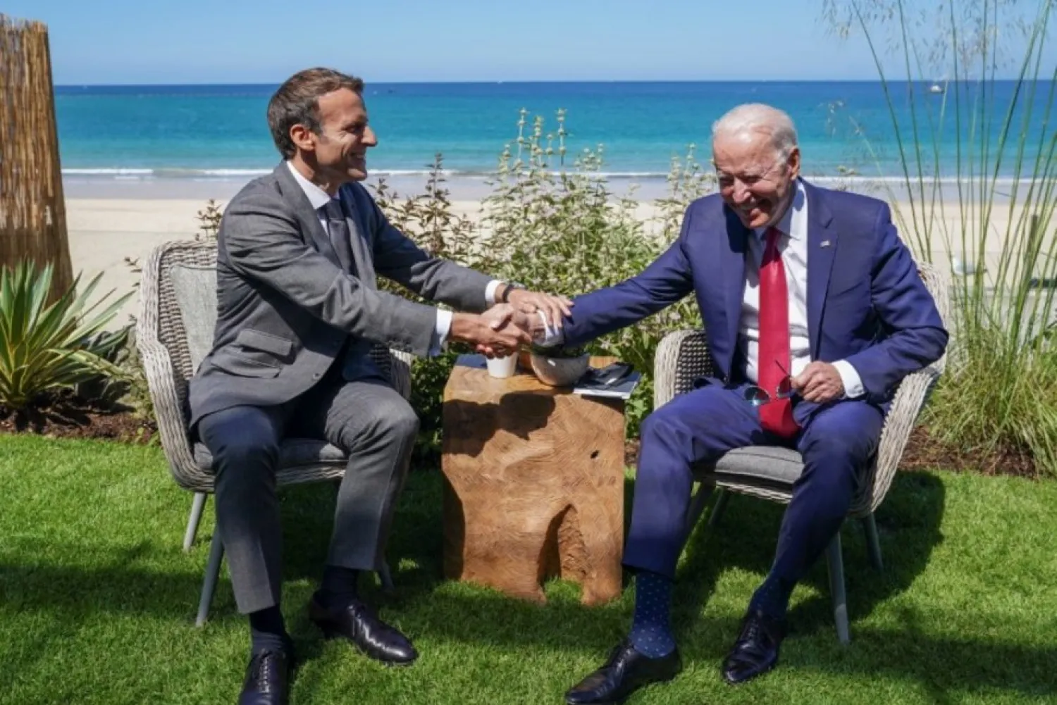 US President Joe Biden and France's President Emmanuel Macron shake hands as they attend a bilateral meeting during the G7 summit in Carbis Bay, Cornwall, Britain, June 12, 2021. (Reuters)