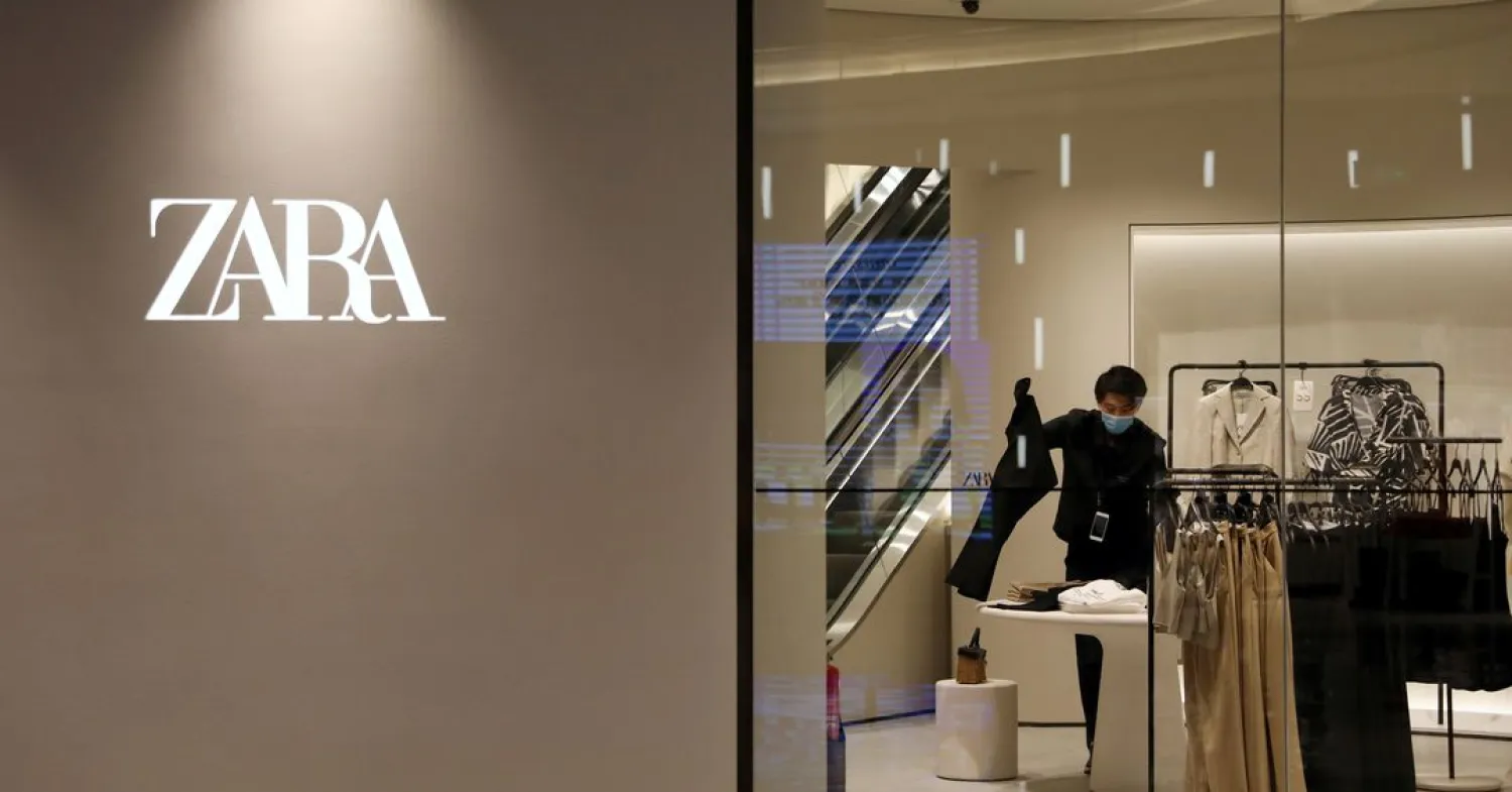 A staff member sorts clothes inside a clothing store of Inditex's Zara brand at a newly opened shopping mall in Beijing, China April 16, 2021. REUTERS/Tingshu Wang/File Photo
                                                   