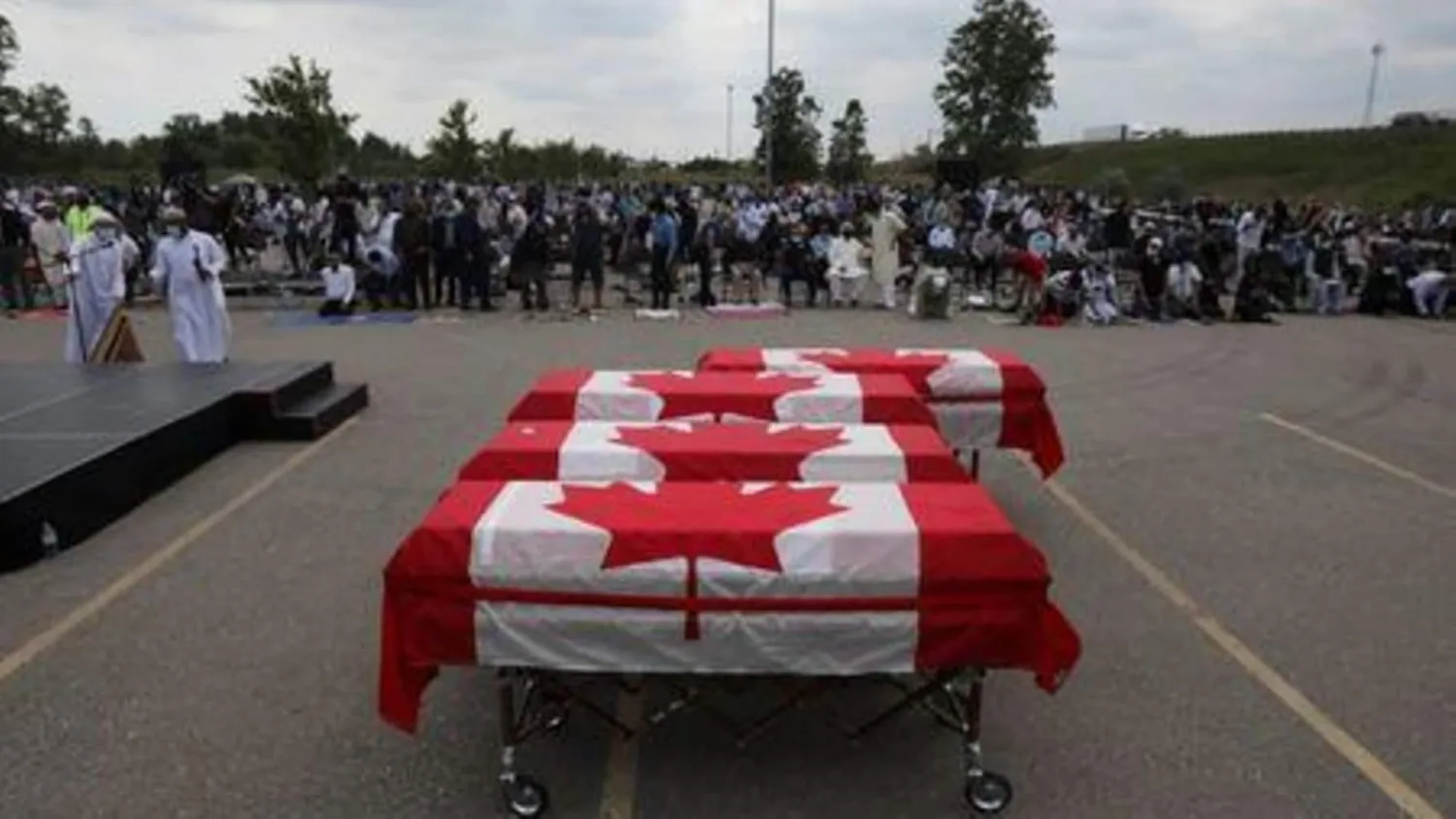 Flag-wrapped coffins are seen outside the Islamic Center of Southwest Ontario, during a funeral of the Afzaal family, in London, Ontario, Canada June 12, 2021. REUTERS/Carlos Osorio