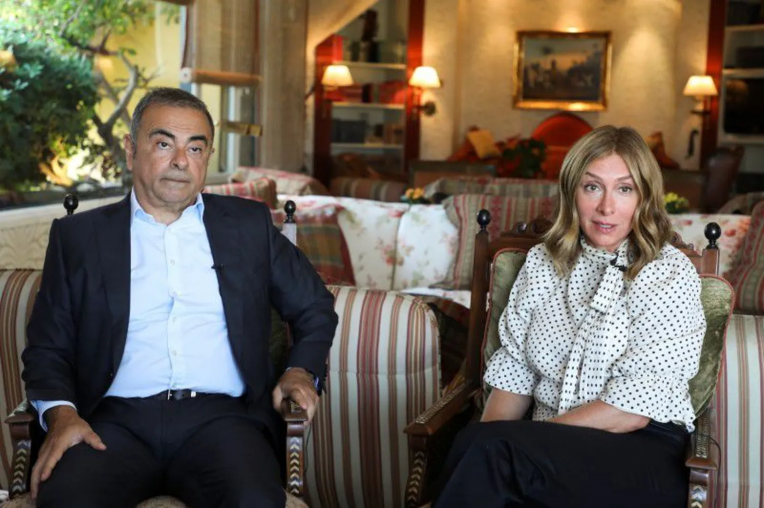 Fugitive former car executive Carlos Ghosn, and his wife Carole Ghosn, talk during an interview with Reuters in Beirut, Lebanon June 14, 2021. (Reuters)
