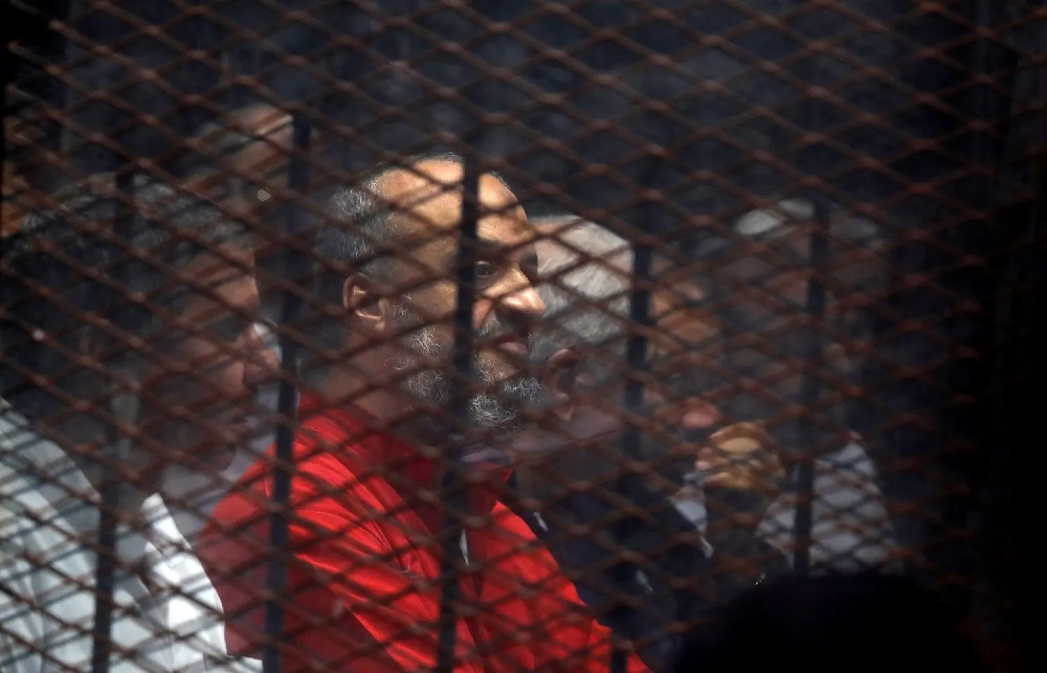 Muslim Brotherhood's senior member Mohamed El-Beltagi sits behind the bars during a court session in Cairo. (Reuters)