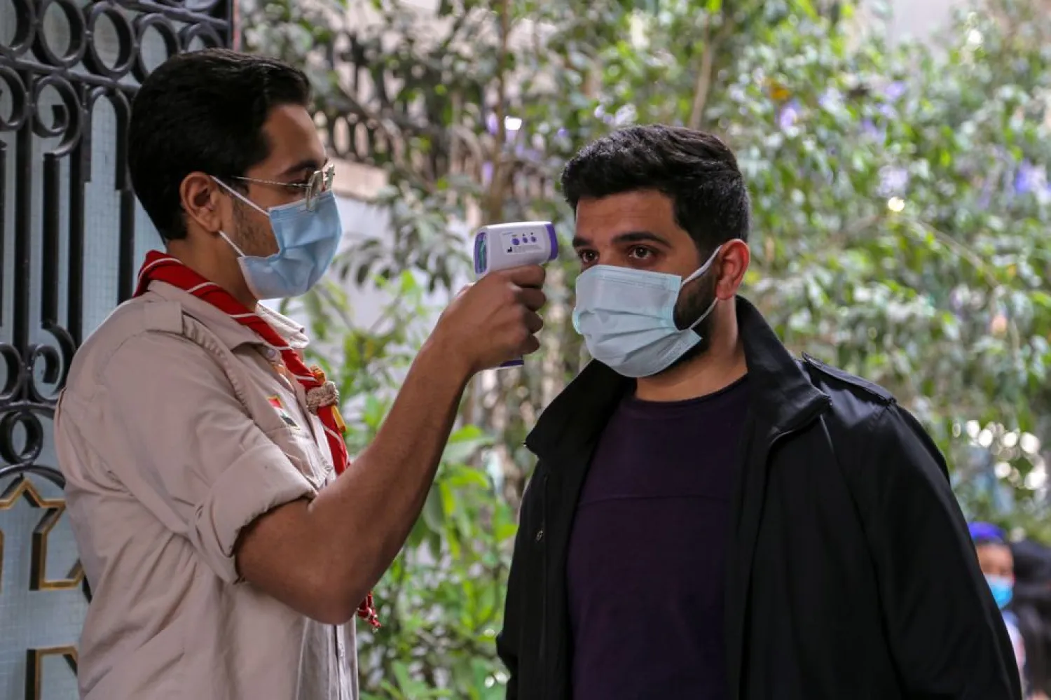 A worshiper has his temperature checked as he arrives to attend a Palm Sunday mass, amid the coronavirus disease (COVID-19) outbreak, in a church in Cairo, Egypt April 25, 2021. (Reuters)