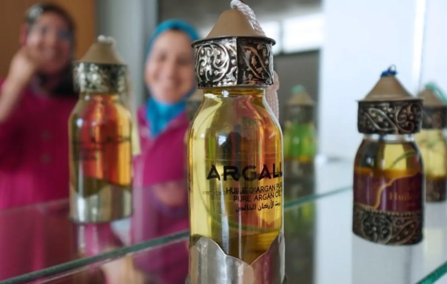 Argan oil bottles are displayed for sale inside the showroom of Women's Agricultural Cooperative Taitmatine, in Agadir, Morocco June 8, 2021. Picture taken June 8, 2021. (Reuters)