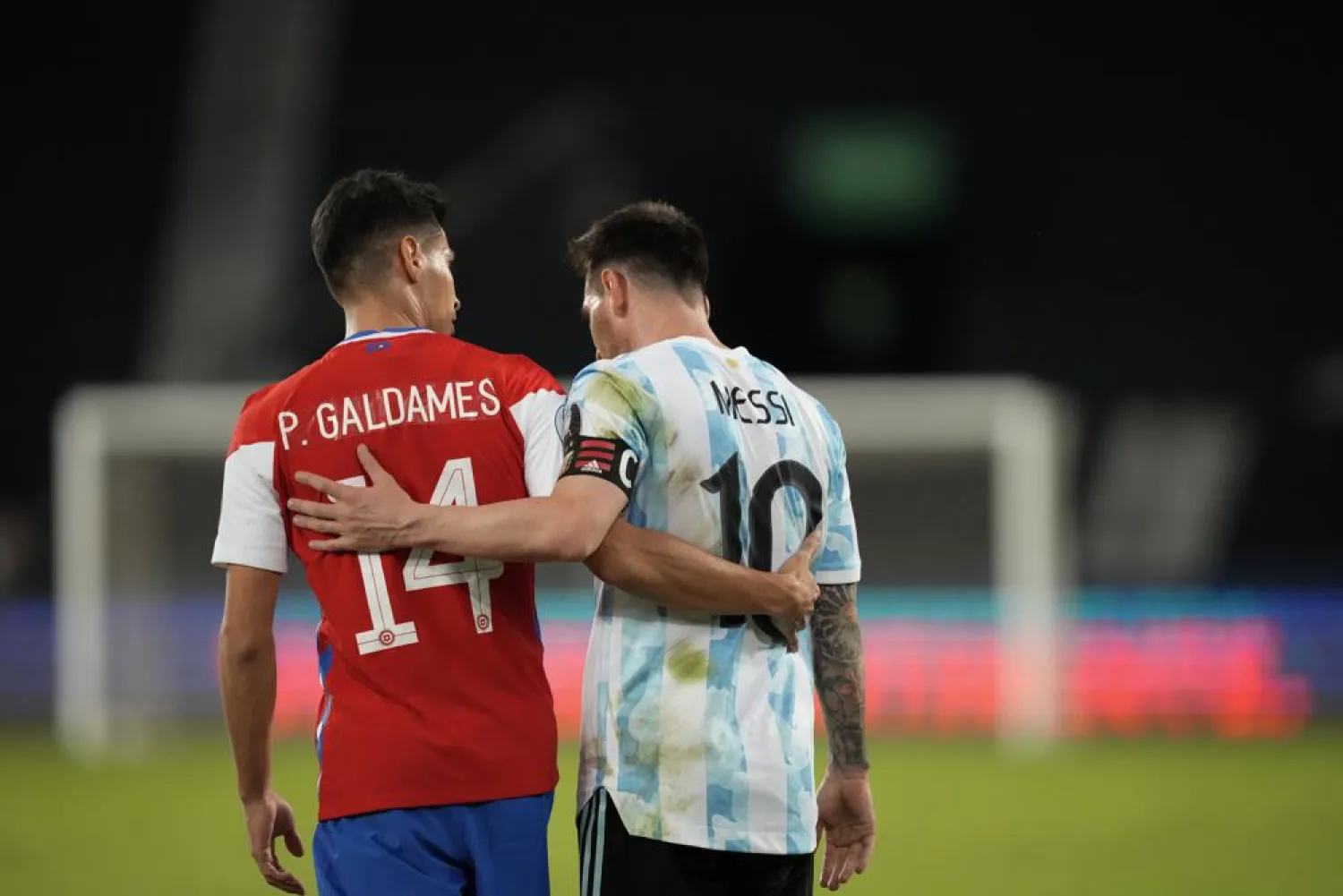 Chile's Pablo Galdames, left, and Argentina's Lionel Messi leave the field after a tie at the end of a Copa America match at the Nilton Santos stadium in Rio de Janeiro, Brazil, Monday, June 14, 2021. (AP)