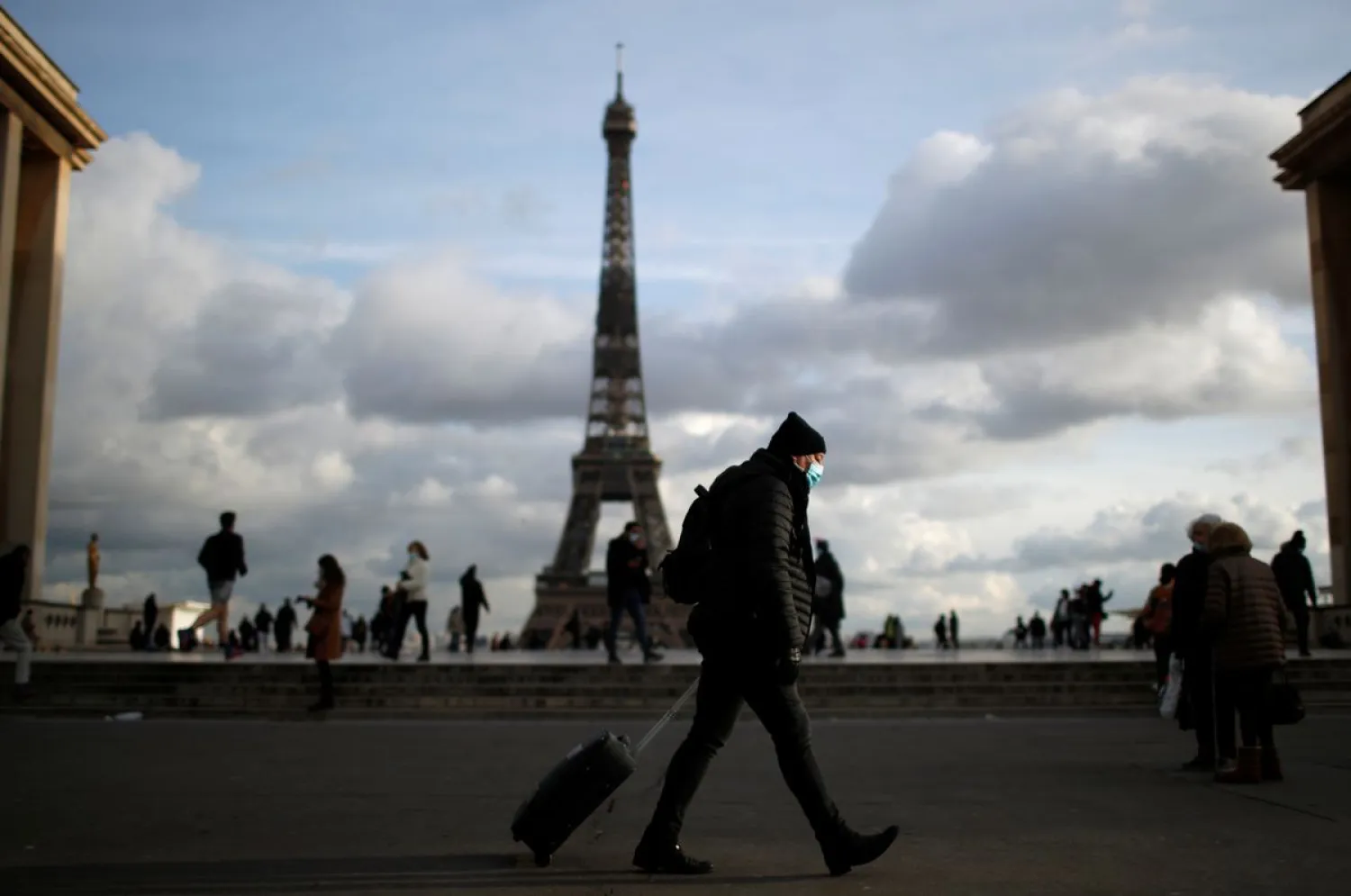 A man wearing a protective face mask walks at Trocadero square near the Eiffel Tower in Paris amid the coronavirus disease (COVID-19) outbreak in France, January 22, 2021. REUTERS/Gonzalo Fuentes