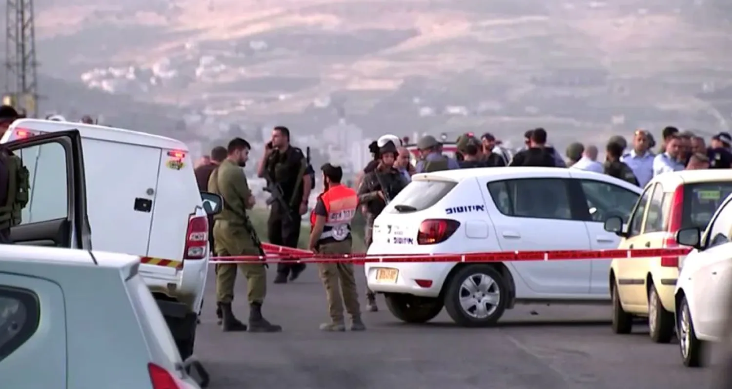 Members of Israeli forces gather at the scene of a shooting incident in the Israeli-occupied West Bank May 2, 2021, in this still image taken from a video. REUTERS/REUTERS TV/


